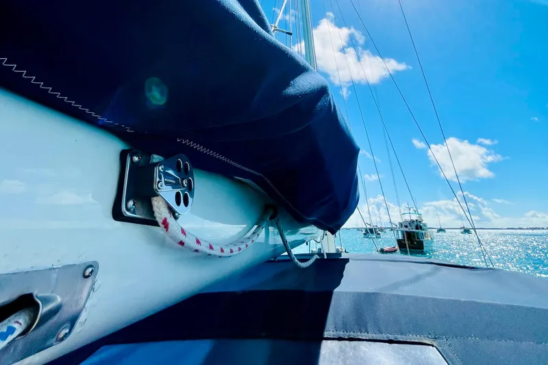 Slide: The Image of 1986 Gulfstar HIRSCH sailboat deck with blue cover, ocean view, and clear sky. - 28