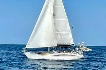 Slide: The Image of 1986 Gulfstar HIRSCH sailboat navigating open sea under clear blue sky. - 3