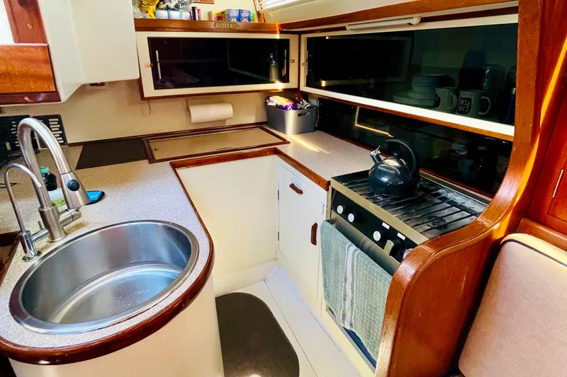 Slide: The Image of 1986 Gulfstar HIRSCH yacht kitchen with sink, stove, and wooden cabinetry. - 40