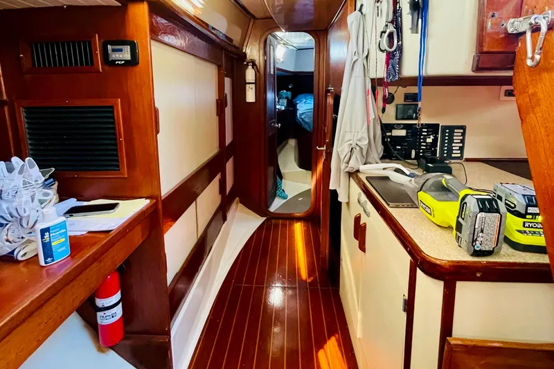 Slide: The Image of Interior of 1986 Gulfstar HIRSCH sailboat with wooden flooring and tools on counter. - 42