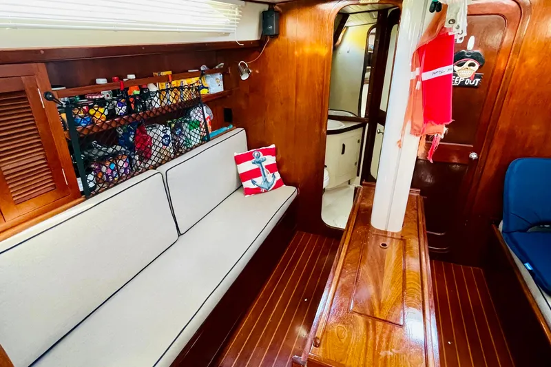 Slide: The Image of 1986 Gulfstar HIRSCH yacht interior with wooden finish, cozy seating, and nautical decor. - 43