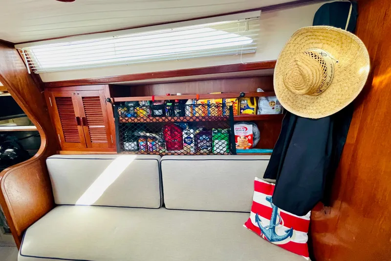 Slide: The Image of 1986 Gulfstar HIRSCH interior with cozy seating, storage, and nautical decor. - 44