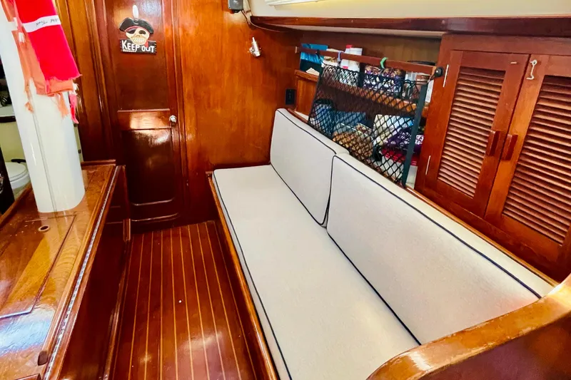 Slide: The Image of 1986 Gulfstar HIRSCH yacht interior with wooden finish and cushioned seating. - 45