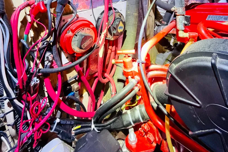 Slide: The Image of 1986 Gulfstar HIRSCH engine compartment with red wiring and mechanical components. - 55