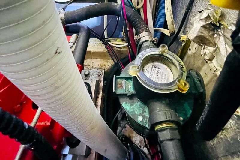 Slide: The Image of Engine compartment of 1986 Gulfstar HIRSCH with visible hoses and mechanical components. - 57