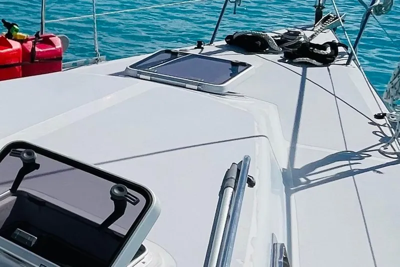 Slide: The Image of 1986 Gulfstar HIRSCH sailboat deck with open hatch, ropes, and calm blue water. - 8