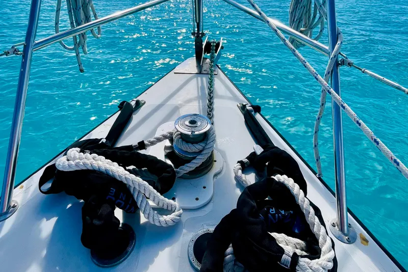 Slide: The Image of Bow of 1986 Gulfstar HIRSCH sailboat on turquoise water, featuring ropes and winch. - 9