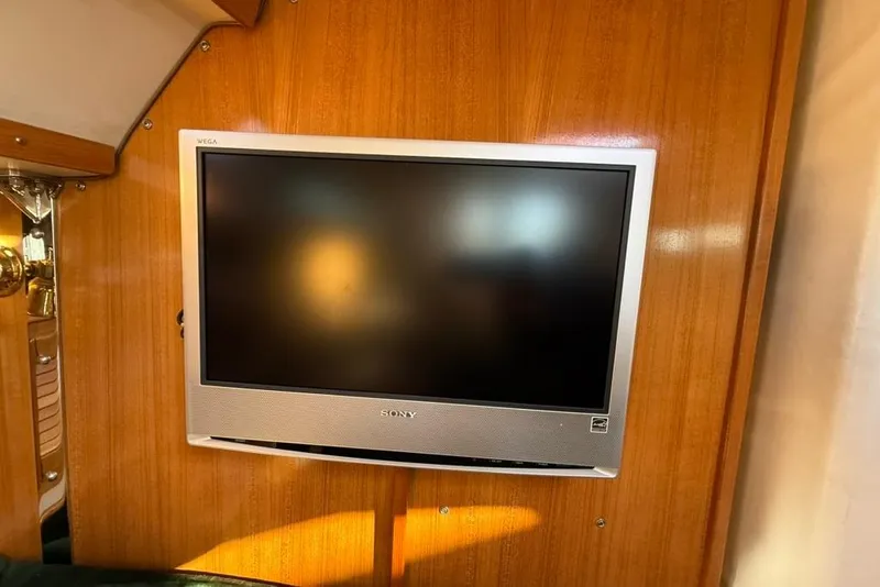 Slide: The Image of Sony TV mounted on wooden panel inside 2004 Catalina 36 MkII yacht. - 13