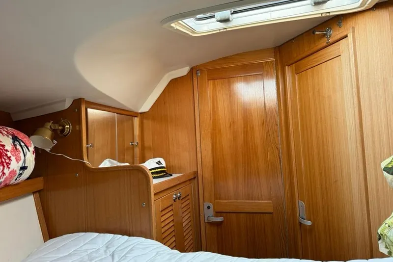 Slide: The Image of Interior cabin of 2004 Catalina 36 MkII sailboat with wooden finish and cozy decor. - 16