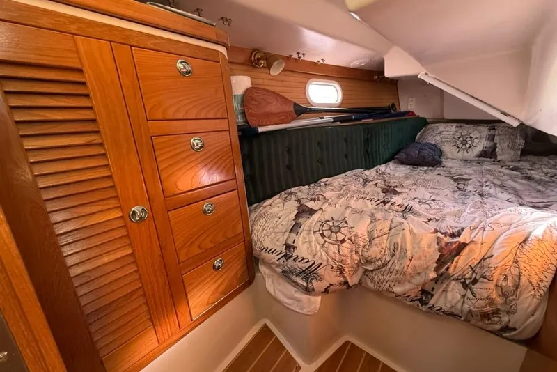 Slide: The Image of Cozy cabin interior of 2004 Catalina 36 MkII sailboat with wooden cabinetry and nautical bedding. - 20
