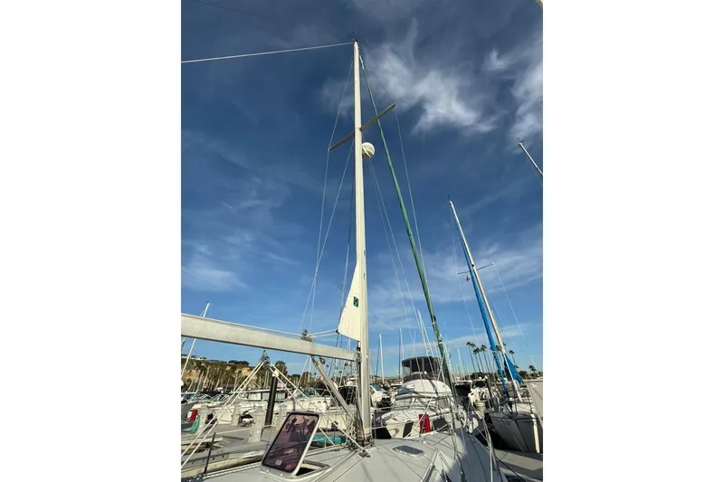 Slide: The Image of 2004 Catalina 36 MkII sailboat docked under a clear blue sky. - 44