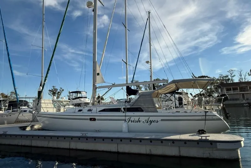 Slide: The Image of 2004 Catalina 36 MkII sailboat docked at marina under blue sky. - 47
