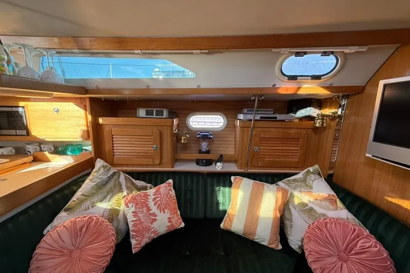 Slide: The Image of Interior of 2004 Catalina 36 MkII sailboat with cozy seating and decorative pillows. - 5