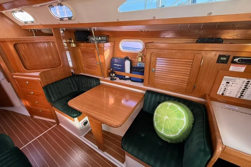 Slide: The Image of Interior of 2004 Catalina 36 MkII sailboat with wooden cabinetry and green seating. - 6
