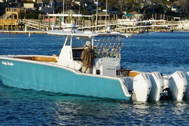 Slide: The Image of 2022 Tideline 365 Offshore boat on water, featuring dual outboard motors. - 11