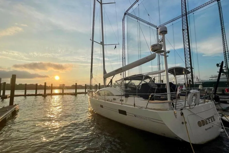 Slide: The Image of Sailing yacht Southerly 57 RS, 2010 model, docked at sunset with scenic waterfront view. - 1