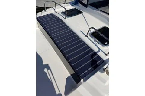 Slide: The Image of 2009 Hunter 50 Center Cockpit deck with striped cushion and handrails. - 13