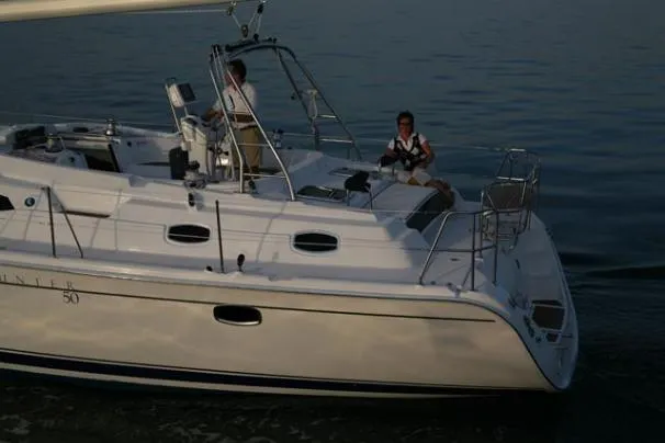 Slide: The Image of 2009 Hunter 50 Center Cockpit sailboat docked at marina under clear blue sky. - 2