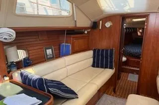 Slide: The Image of 2009 Hunter 50 Center Cockpit interior with cozy seating and wooden accents. - 20