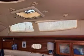 Slide: The Image of Interior of 2009 Hunter 50 Center Cockpit yacht with skylight and wooden paneling. - 21