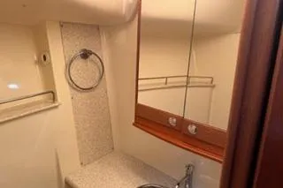 Slide: The Image of 2009 Hunter 50 Center Cockpit bathroom with mirror, sink, and towel ring. - 27