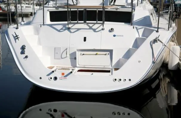 Slide: The Image of 2009 Hunter 50 Center Cockpit sailboat docked at marina under clear blue sky. - 3