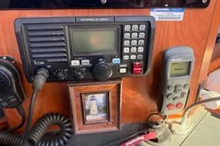 Slide: The Image of 2009 Hunter 50 Center Cockpit radio and control panel with lighthouse photo. - 31