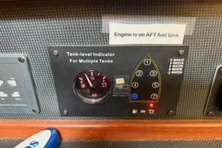 Slide: The Image of Control panel of a 2009 Hunter 50 Center Cockpit with tank-level indicator and fuel tank notice. - 34