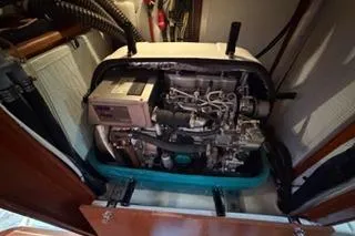 Slide: The Image of Engine compartment of a 2009 Hunter 50 Center Cockpit sailboat, showcasing mechanical components. - 42