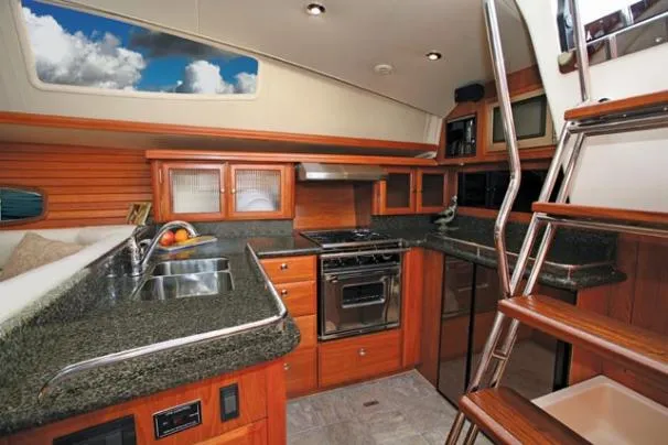 Slide: The Image of 2009 Hunter 50 Center Cockpit sailboat docked in a marina with other boats. - 5