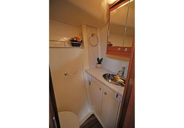 Slide: The Image of 2009 Hunter 50 Center Cockpit sailboat docked in a marina, featuring a spacious cockpit. - 8