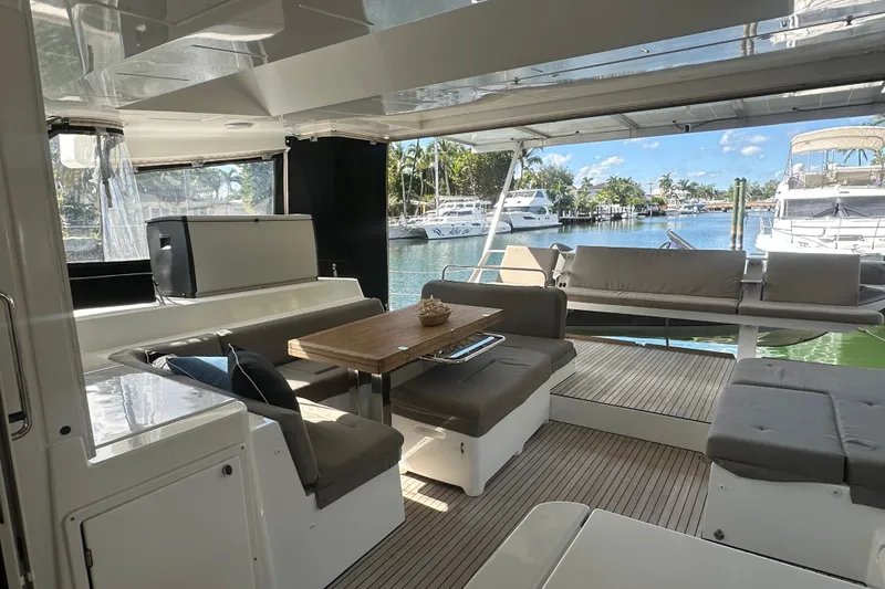 Slide: The Image of Luxurious 2017 Lagoon 52 F yacht interior with elegant seating and scenic marina view. - 18