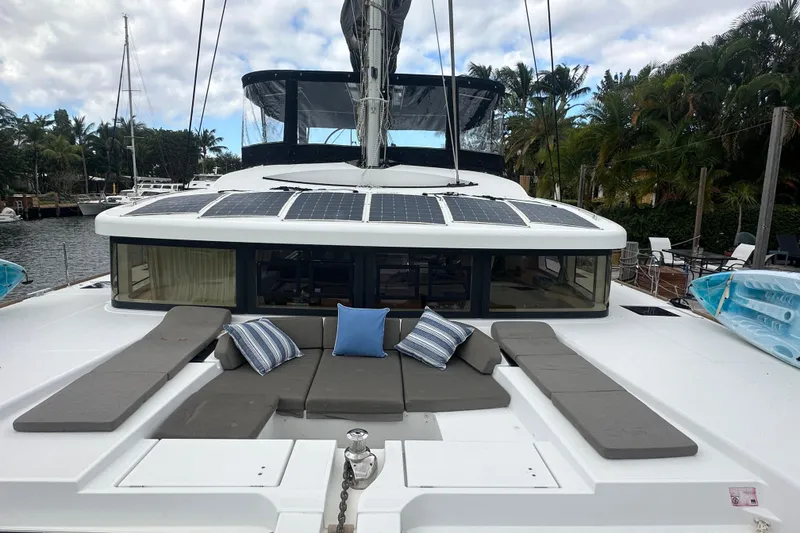 Slide: The Image of 2017 Lagoon 52 F catamaran with solar panels and cushioned seating on deck. - 2