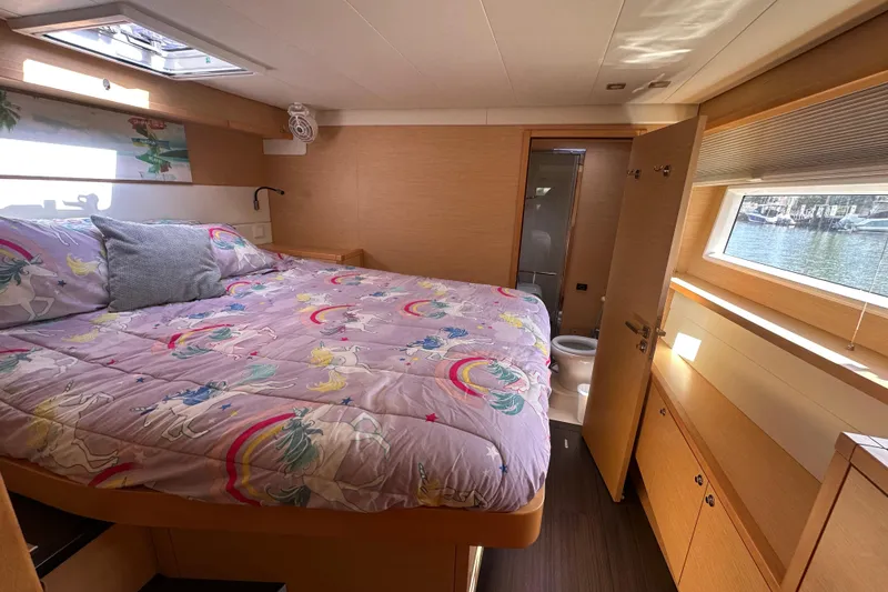 Slide: The Image of Luxurious cabin interior of 2017 Lagoon 52 F yacht with unicorn-themed bedding. - 41