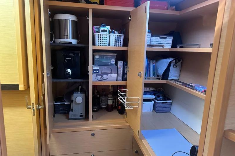 Slide: The Image of Cabinet interior on 2017 Lagoon 52 F yacht, featuring organized kitchen appliances and storage baskets. - 45