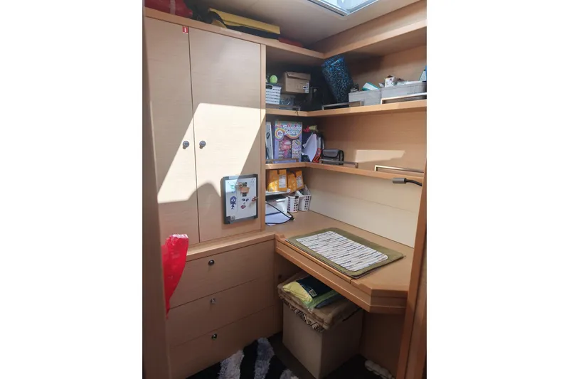 Slide: The Image of Interior of 2017 Lagoon 52 F yacht with organized storage and desk area. - 46