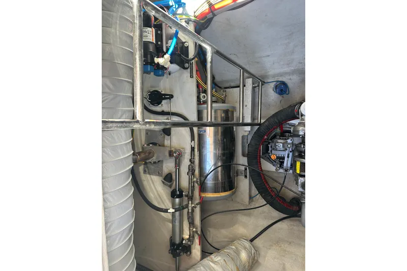 Slide: The Image of Engine compartment of a 2017 Lagoon 52 F yacht, showcasing mechanical components and wiring. - 52