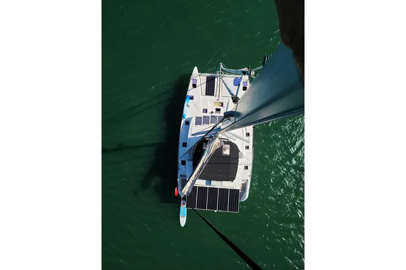 Slide: The Image of Aerial view of 2017 Lagoon 52 F catamaran with solar panels on green water. - 7