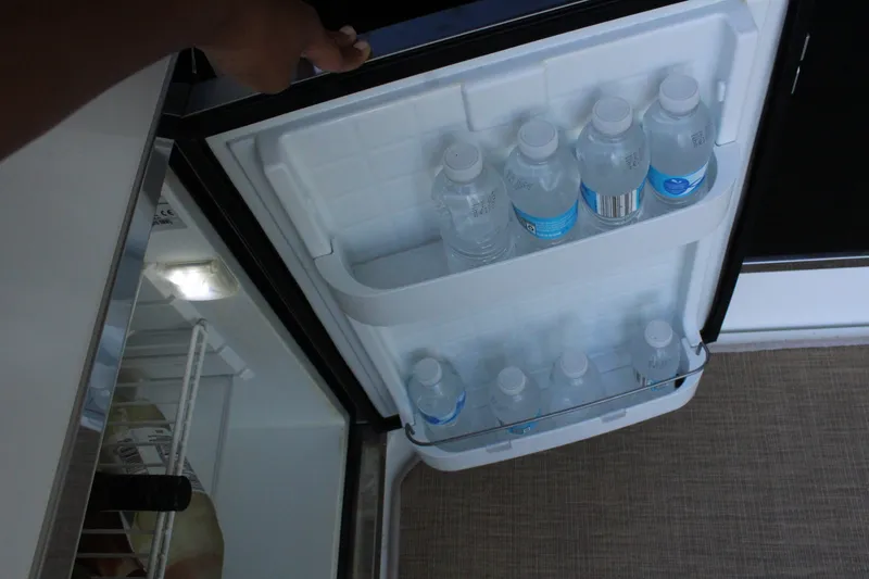 Slide: The Image of Refrigerator in 2014 Cruisers Yachts 45 Cantius with water bottles. - 11