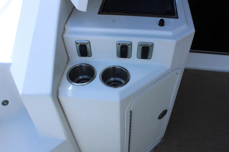 Slide: The Image of Cup holders and switches on a 2014 Cruisers Yachts 45 Cantius. - 13
