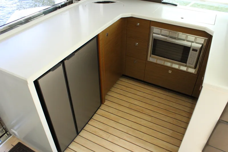 Slide: The Image of 2014 Cruisers Yachts 45 Cantius kitchen area with microwave and refrigerator. - 17