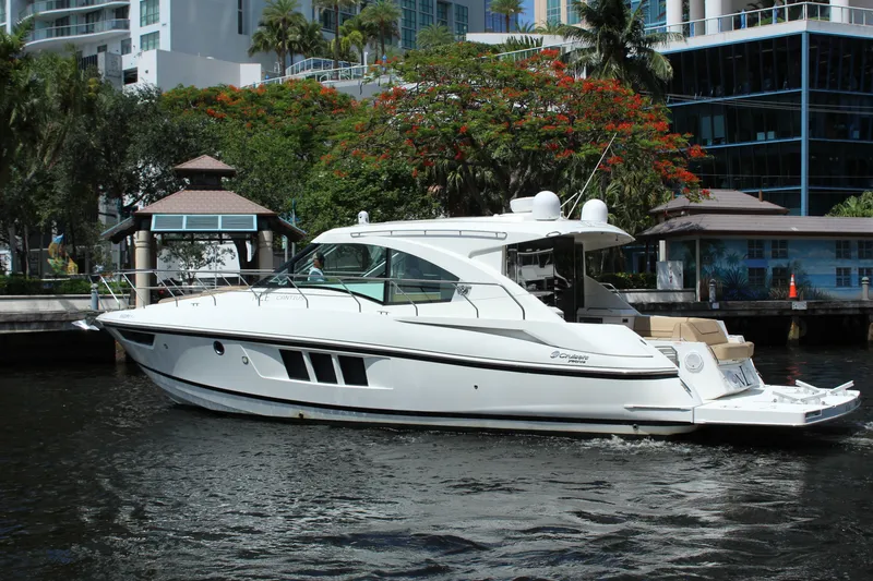 Slide: The Image of 2014 Cruisers Yachts 45 Cantius on a river with modern buildings. - 3