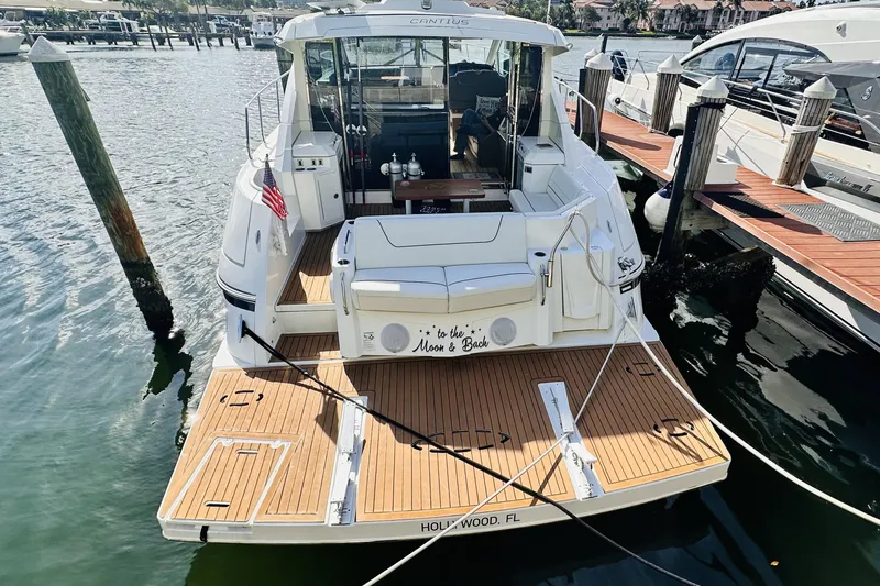 Slide: The Image of 2014 Cruisers Yachts 45 Cantius docked, featuring spacious deck and elegant design. - 74