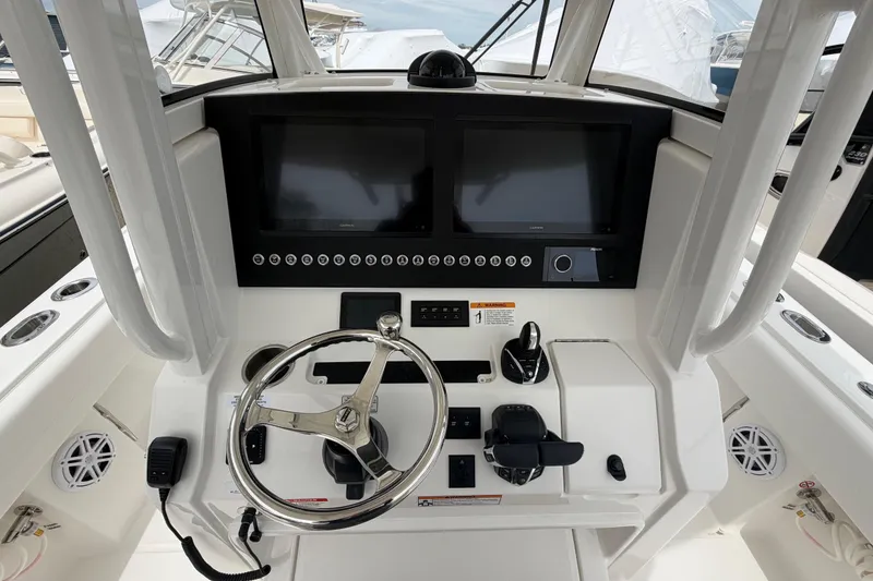 Slide: The Image of 2026 Regulator 28 boat helm with dual screens and modern controls. - 15