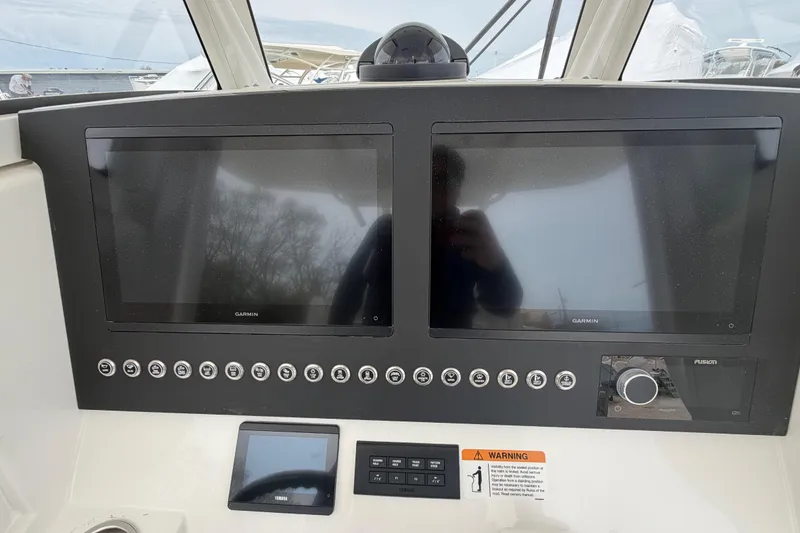 Slide: The Image of Helm of 2026 Regulator 28 boat with dual Garmin displays and control panel. - 16