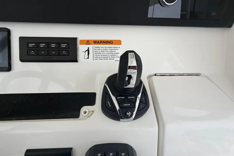 Slide: The Image of Control panel of a 2026 Regulator 28 boat with joystick and warning label. - 17