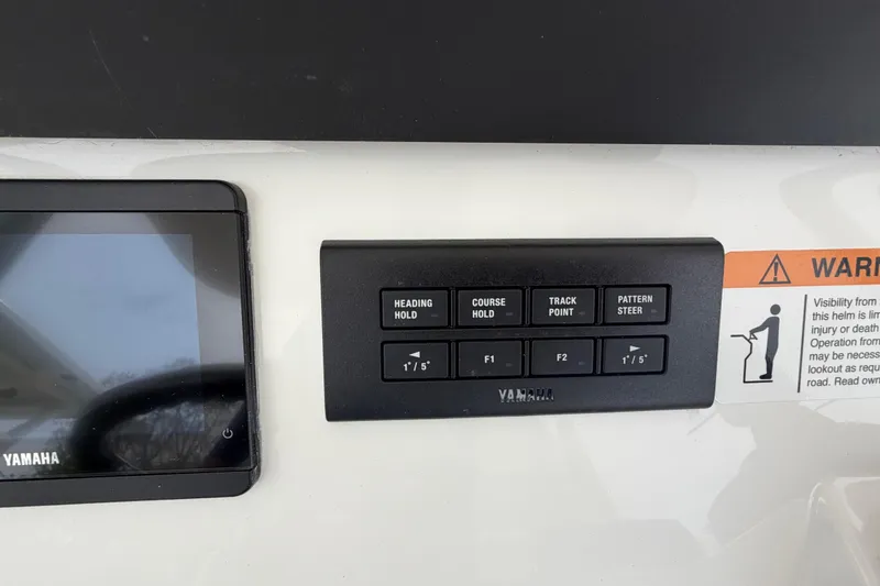 Slide: The Image of Control panel of a 2026 Regulator 28 boat with Yamaha interface and warning label. - 18