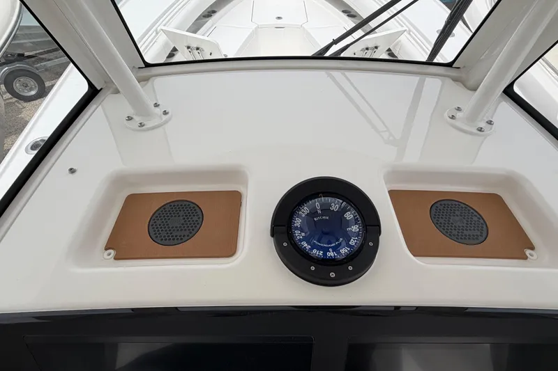 Slide: The Image of 2026 Regulator 28 boat dashboard with compass and speaker panels. - 20