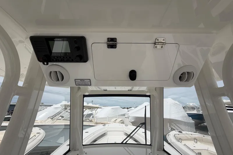 Slide: The Image of 2026 Regulator 28 boat interior with Garmin device and storage compartment. - 21