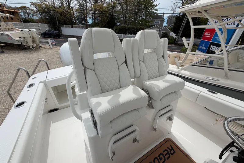 Slide: The Image of 2026 Regulator 28 boat with luxurious white seating and modern design features. - 23